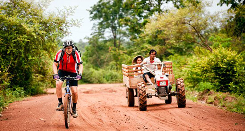Cycling the red dirt roads just outside Champasak