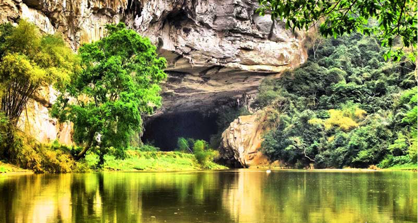 A boat tour on Nang River goes through the Puong Cave