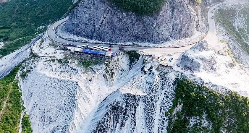 The pass is outstanding in white among mountains and forests