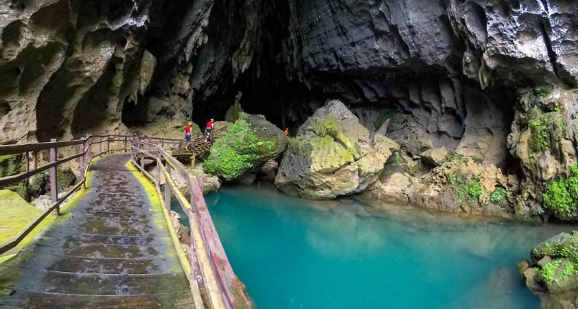 A wooden bridge leads to Light Cave