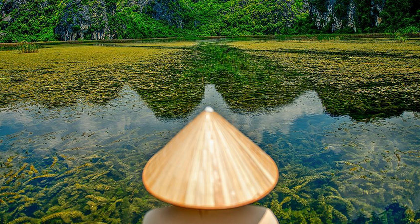 The water is so clear that tourists can see the bottom with weed layers