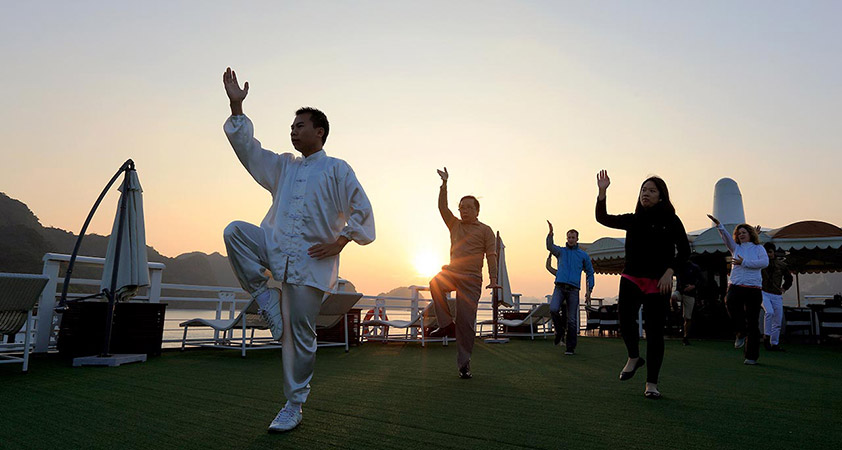 Greet the day with a morning tai chi session, admire the sunrise over the bay