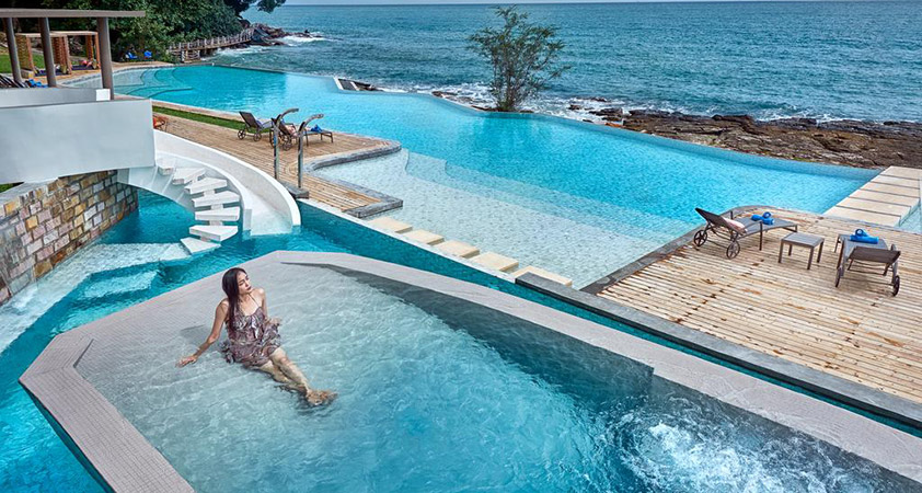 Immersing in the blue water of a swimming pool near the beach