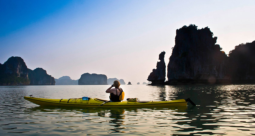 Paddling by kayak on Halong bay